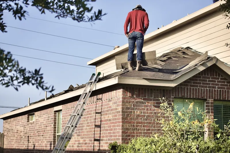 Professional roofer working on a residential roof in Milestone Corner